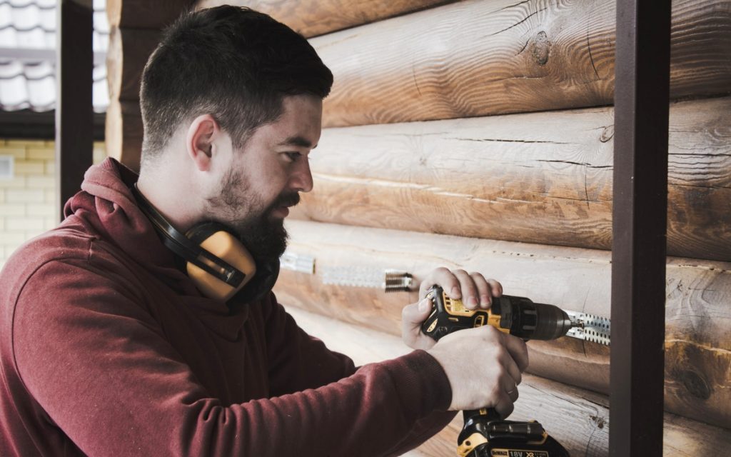 Builder in Spain working on a wooden house